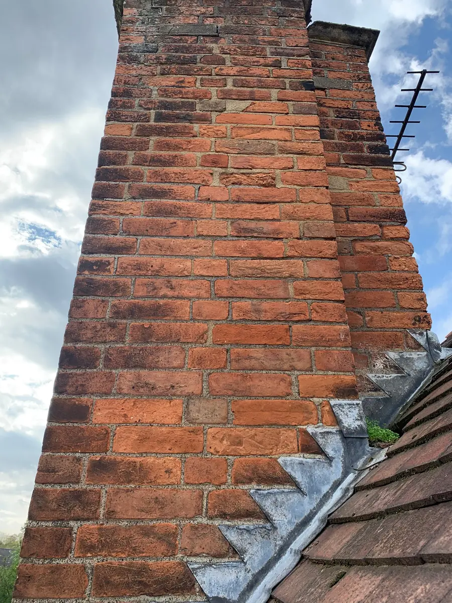 Lime-repointed chimney stacks and re-laid handmade clay tiles
