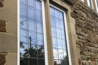 Slim-frame glazing set in original stone mullions