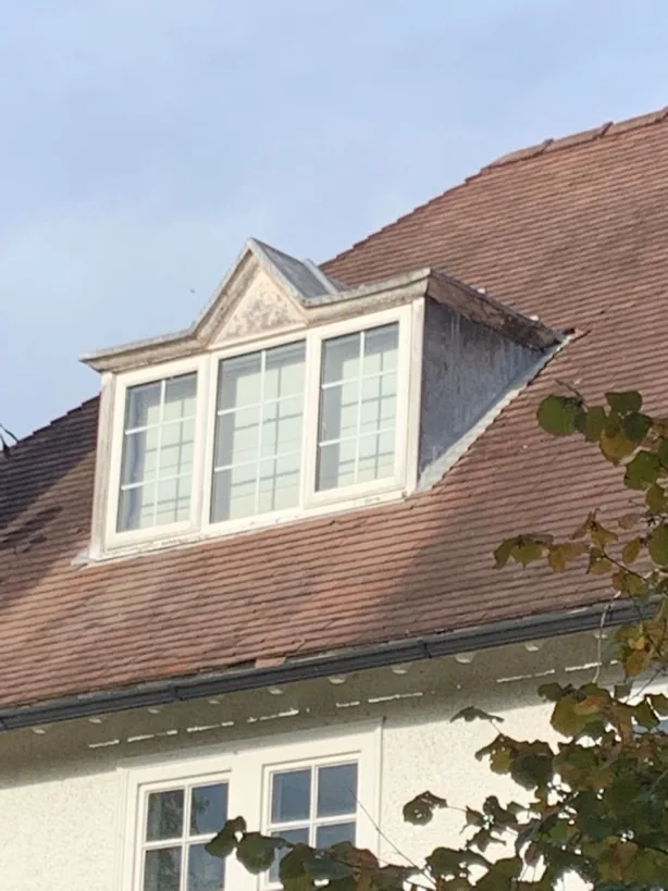 Dormer window set into the clay-tiled roof slope