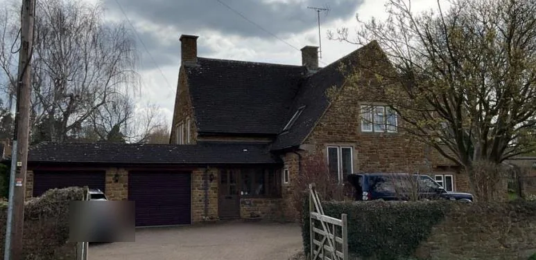 Orchard House, a 1970 rubble-stone house near Banbury, seen from the road