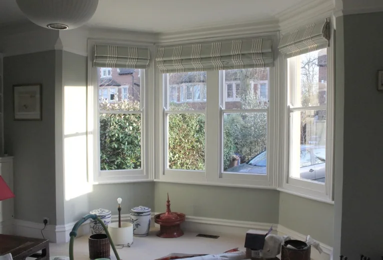 The ground-floor bay with timber sash windows