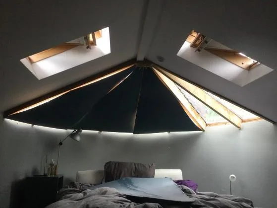The room-in-roof main bedroom with faceted turret ceiling and rooflights